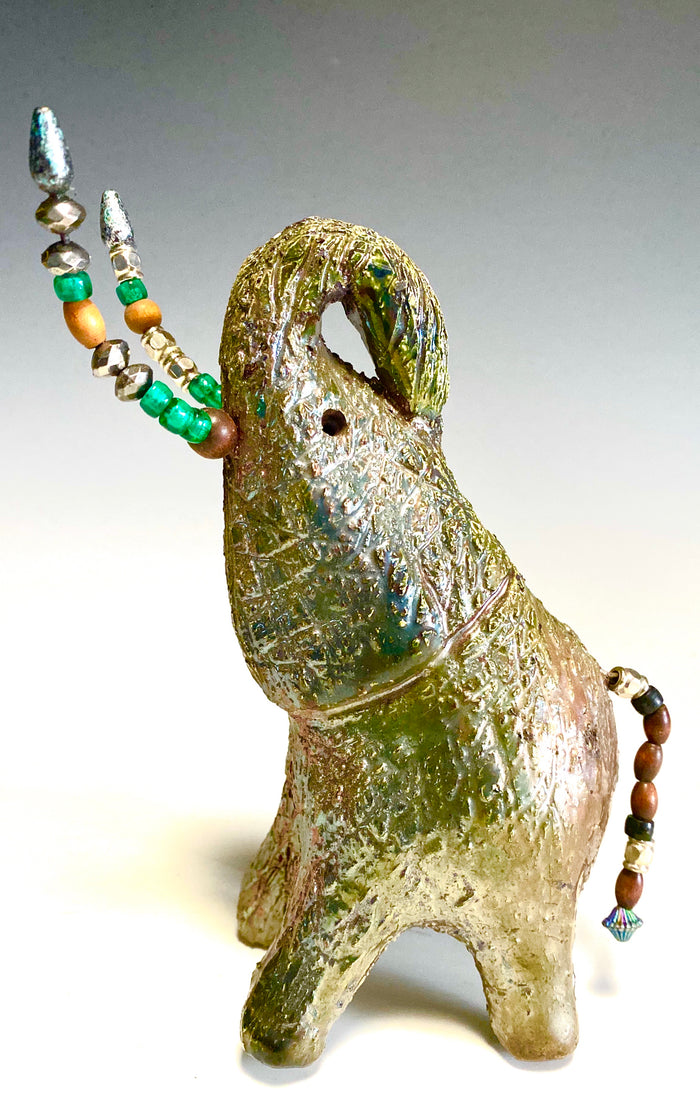 Raku Elephant Have you HERD!!!!!! Just one of these lovely Raku Fired Elephant will make an excellent gift for your friend, sorority or for your home’ special place centerpiece. 7.5" x 4" x 7" 1.10 lbs Multi beaded tusk Beautiful metallic copper gold raku glazes For decorative purposely only.