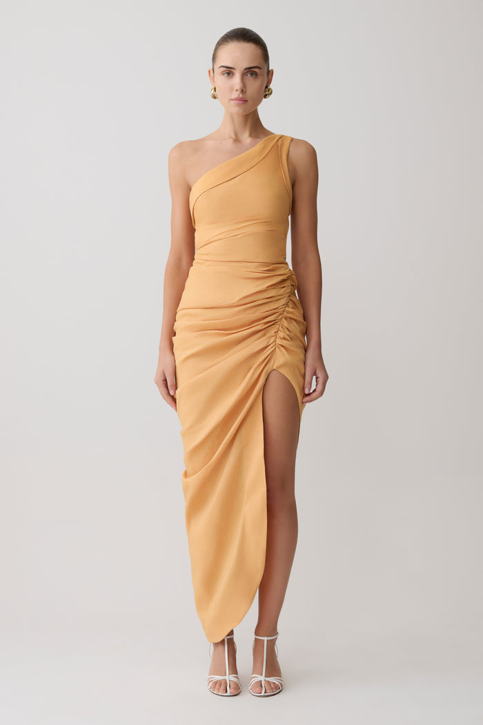 Woman wearing a yellow one-shoulder dress on a white background
