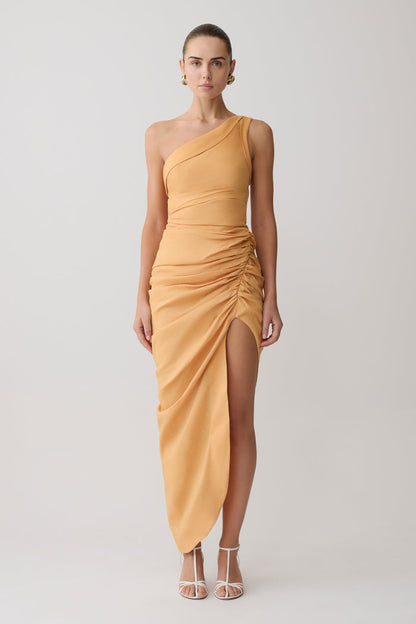 Woman wearing a yellow one-shoulder dress on a white background