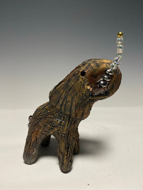 Have you HERD!!!!!!   Elephants are one of my favorite animals to create. They are so majestic"  Just one of these lovely Raku Fired Elephant will make an excellent gift for your  BFF,  or just for you .    This raku fired baby elephant sits 6" x 4" x 4" and weighs 10 ounces. She has beaded tusks and a textured copper body.  This little baby is Nice!