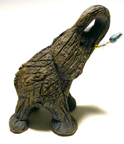 Elephants are one of my favorite animals to create. They are so majestic"  Just one of these lovely Raku Fired Elephant will make an excellent gift for your  BFF,  or just for you .    This raku fired elephant stands 7" x 2" x 2.5" and weighs  7 ounces. She has beaded tusks and a textured charcoal  body. Nice!