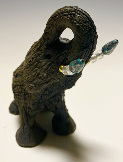 Elephants are one of my favorite animals to create. They are so majestic"  Just one of these lovely Raku Fired Elephant will make an excellent gift for your  BFF,  or just for you .    This raku fired elephant stands 7" x 2" x 2.5" and weighs  7 ounces. She has beaded tusks and a textured charcoal  body. Nice!