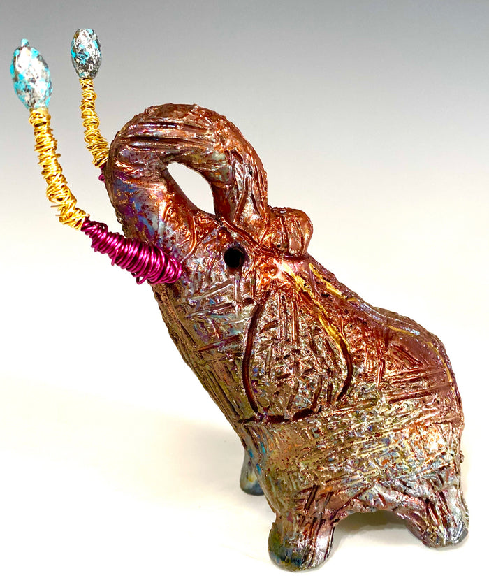 Raku Elephant Have you HERD!!!!!!  Just one of these lovely Raku Fired Elephant will make an excellent gift for your  friend, sorority or for your home’ special place centerpiece.   6" x 3" x 5" 1 lbs Beautiful metallic raku elephant For decorative purposely only