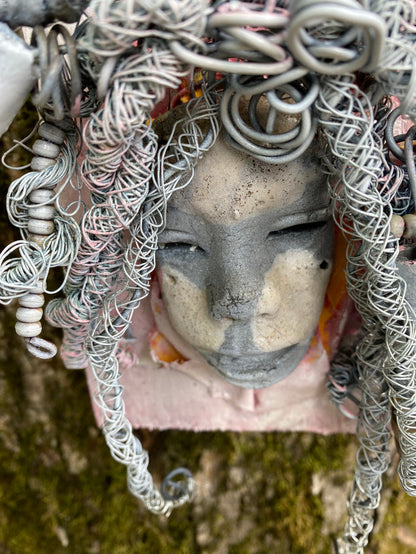 Bring a bit of quirk to your walls with Venice! This one-of-a-kind folk art piece is mounted on a painted 5”x 6” wood canvas and features over 40 feet of wired hair and Raku beads! With white , antique crackle face and lips, she is sure to liven up any space. Whether you want a conversation starter or just an eye-catching piece of art, Venice is ready to be hung! Got questions? Just ask!Got Questions??