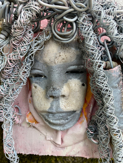 Bring a bit of quirk to your walls with Venice! This one-of-a-kind folk art piece is mounted on a painted 5”x 6” wood canvas and features over 40 feet of wired hair and Raku beads! With white , antique crackle face and lips, she is sure to liven up any space. Whether you want a conversation starter or just an eye-catching piece of art, Venice is ready to be hung! Got questions? Just ask!Got Questions??