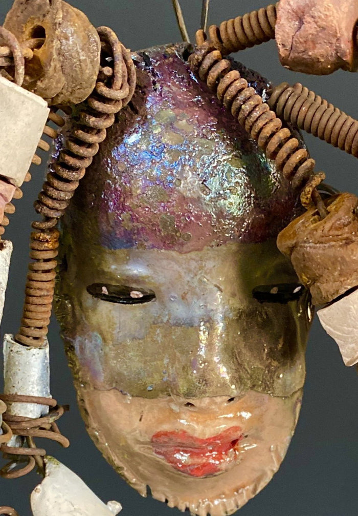 I started making art soon after seeing authentic African artwork at the Smithsonian Museum of African Art. I was in total awe. Jerri was inspired by my visit there.  Jerri has a two tone copper gold complexion. She is 8" x 5" and weighs  11 ozs. Jerri has over 20 handmade raku fired beads. Jerri has over 10 feet of  copper coiled 16 gauge wire hair.