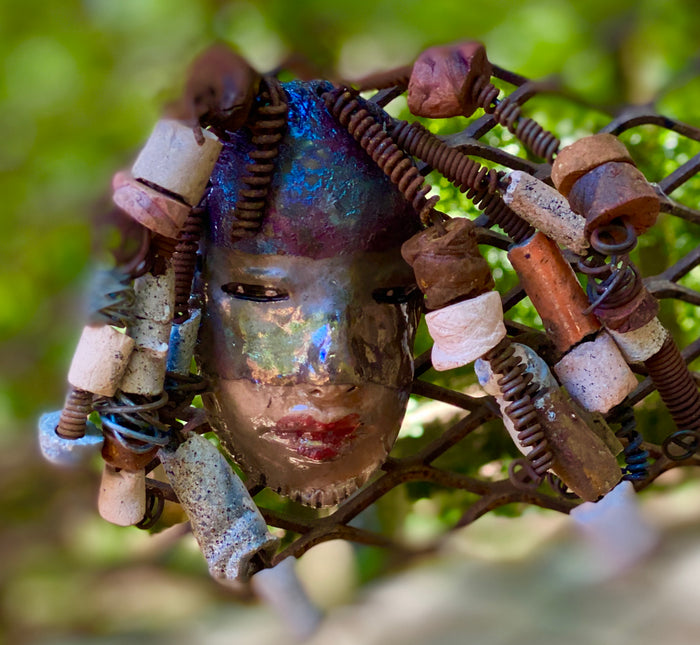 I started making art soon after seeing authentic African artwork at the Smithsonian Museum of African Art. I was in total awe. Jerri was inspired by my visit there.  Jerri has a two tone copper gold complexion. She is 8" x 5" and weighs  11 ozs. Jerri has over 20 handmade raku fired beads. Jerri has over 10 feet of  copper coiled 16 gauge wire hair.