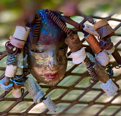 I started making art soon after seeing authentic African artwork at the Smithsonian Museum of African Art. I was in total awe. Jerri was inspired by my visit there.  Jerri has a two tone copper gold complexion. She is 8" x 5" and weighs  11 ozs. Jerri has over 20 handmade raku fired beads. Jerri has over 10 feet of  copper coiled 16 gauge wire hair.