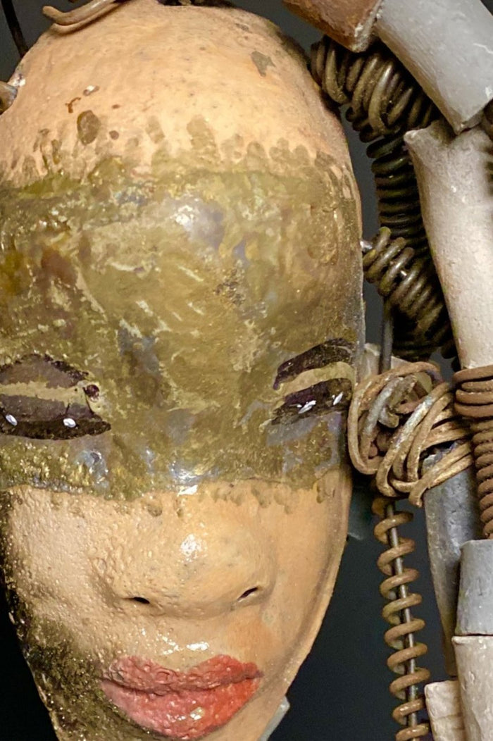I started making art soon after seeing authentic African artwork at the Smithsonian Museum of African Art. I was in total awe. Kia was inspired by my visit there.   Kia has a light and dark honey brown complexion. Her hair can be adjusted up to  11" x 10" and weighs 1.09 lbs Kia has  over 20 handmade multicolored raku fired beads. She has over 20 feet of coiled 16 gauge wire hair. Kia is ready for display!