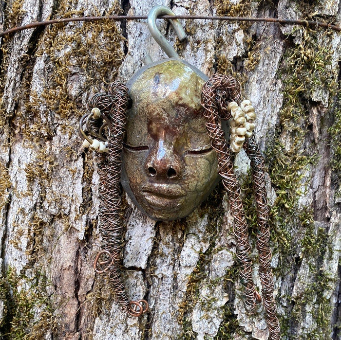nspired by a visit to the Smithsonian Museum of African Art, I began creating art shortly thereafter. Mina is a 4”x 6” figurine crafted with a glossy copper and off white complexion, and spiral coils of hair adorned with small white speckle beads. Weighing 5.6 ozs., she is ready to be hung in a special place!