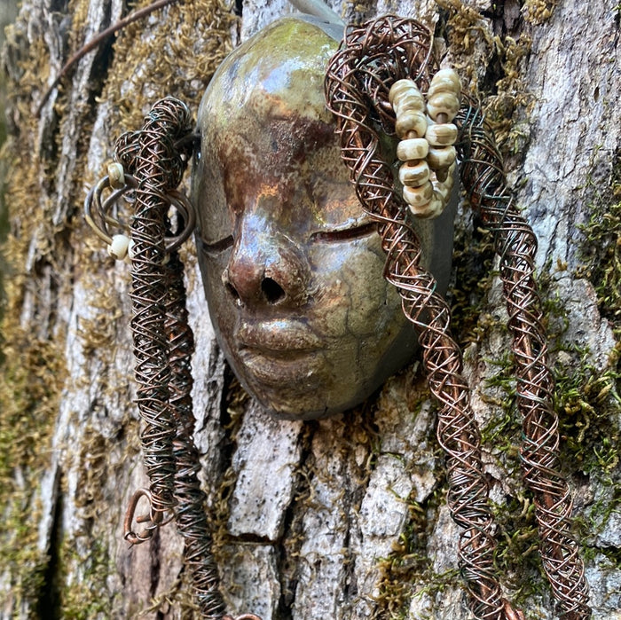 nspired by a visit to the Smithsonian Museum of African Art, I began creating art shortly thereafter. Mina is a 4”x 6” figurine crafted with a glossy copper and off white complexion, and spiral coils of hair adorned with small white speckle beads. Weighing 5.6 ozs., she is ready to be hung in a special place!