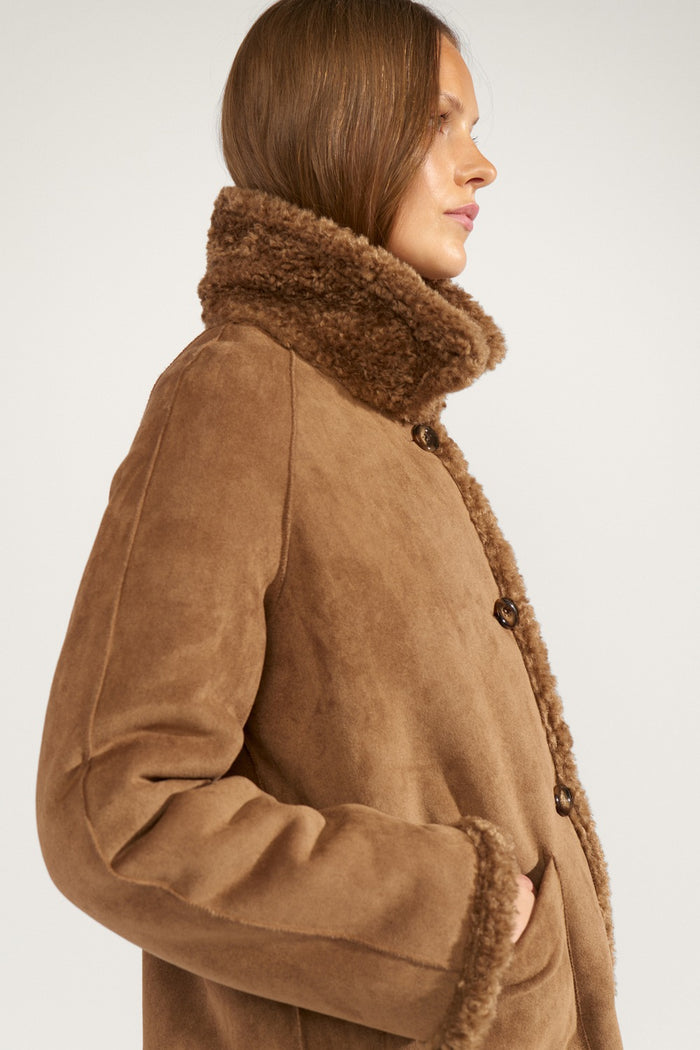 Side profile of a model wearing Numph 706900 NUMINDA Reversible Jacket – Dachshund by Numph, shop Numph at Dotique
