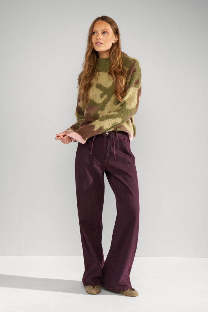 Model wearing Numph 707195 Nucamu Jumper Calla Green by Numph, shop Numph at Dotique for stylish knitwear options