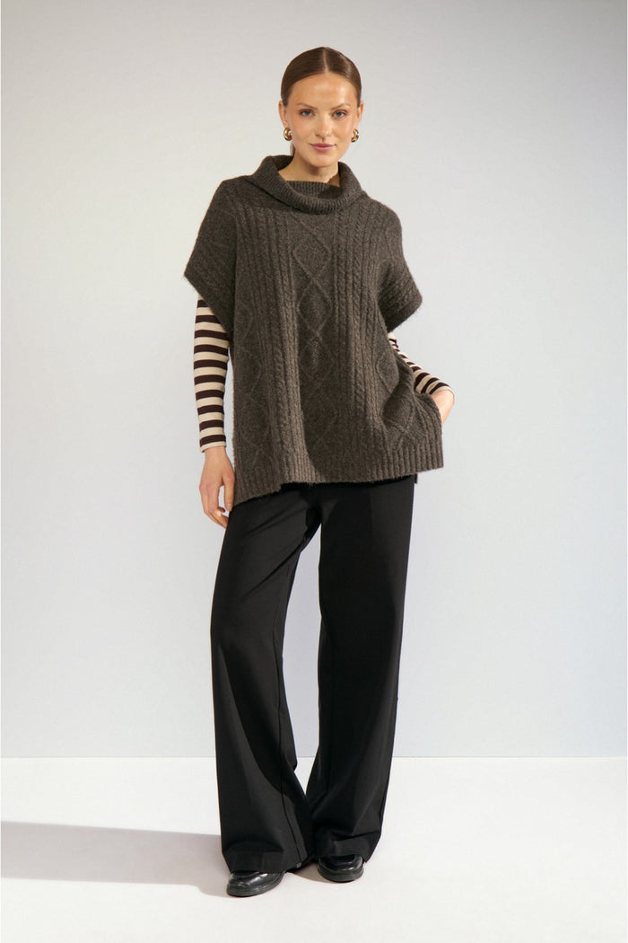 Model wearing Numph 707241 Nujoline Poncho Black Coffee by Numph, shop the vendor at Dotique for stylish knitwear options