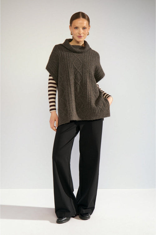Model wearing Numph 707241 Nujoline Poncho Black Coffee by Numph, shop the vendor at Dotique for stylish knitwear options