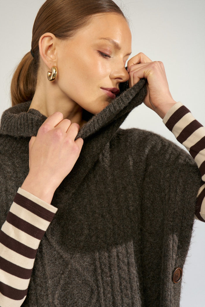 Close-up of model wearing Numph 707241 Nujoline Poncho Black Coffee by Numph, shop the vendor at Dotique for stylish layering