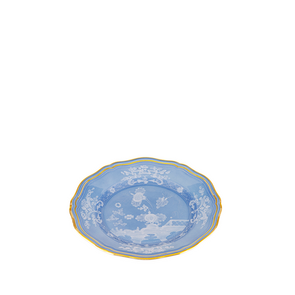 Blue bread and butter plate with white floral and vine patterns, scalloped gold rim.
