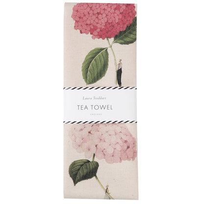 The Laura Stoddart Tea Towel in retail packaging, rapped in a white paper belly band.
