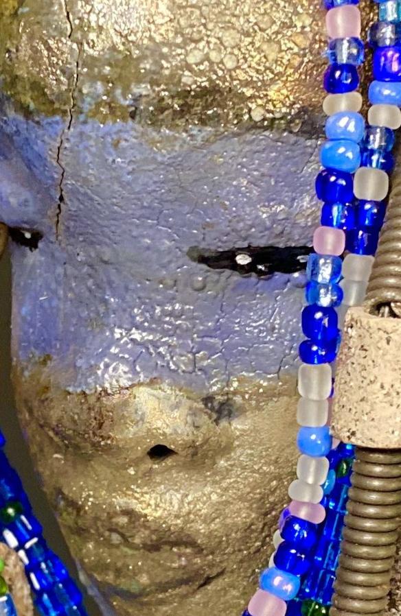 Meet Randi! I started making art soon after seeing authentic African artwork at the Smithsonian Museum of African Art. I was in total awe. Randi was inspired by my visit there.   Randi has a two tone complexion of golden silver and blue. She is 8" x 6" and weighs 14 ozs. Randi has over 10 raku beads. She has over 200 of multi shade of blue and white mini beads. Randi has over 10 feet of  coiled copper and 16 gauge wire hair.