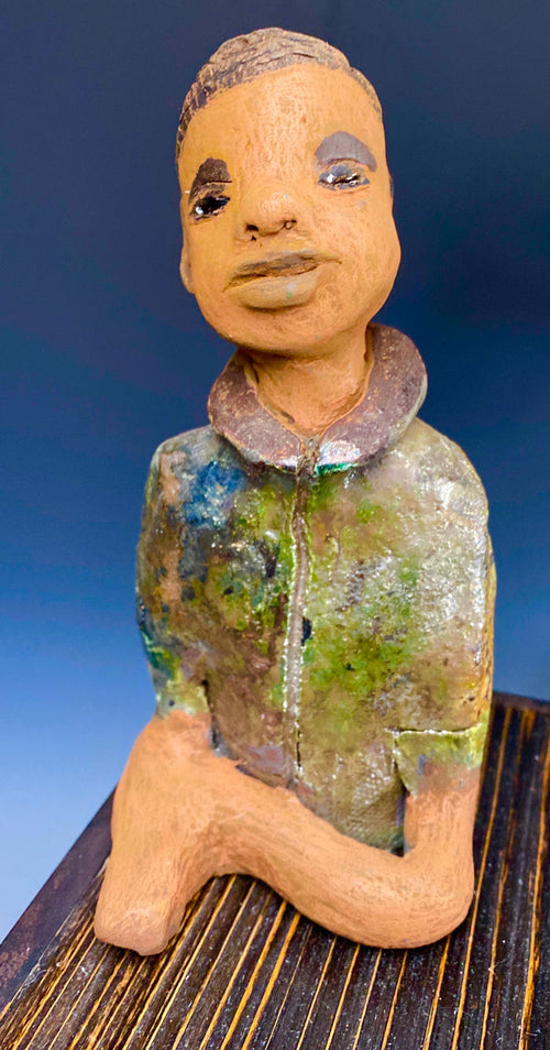 Ray is one confident teen who is ready to make his mark!  Ray stands 7"x 3" x 3" and weighs 14 ozs. He has a green metallic jacket with a high collar . Ray complexion is honey brown. His arms are folded as he ponders which college scholarship to accept!!