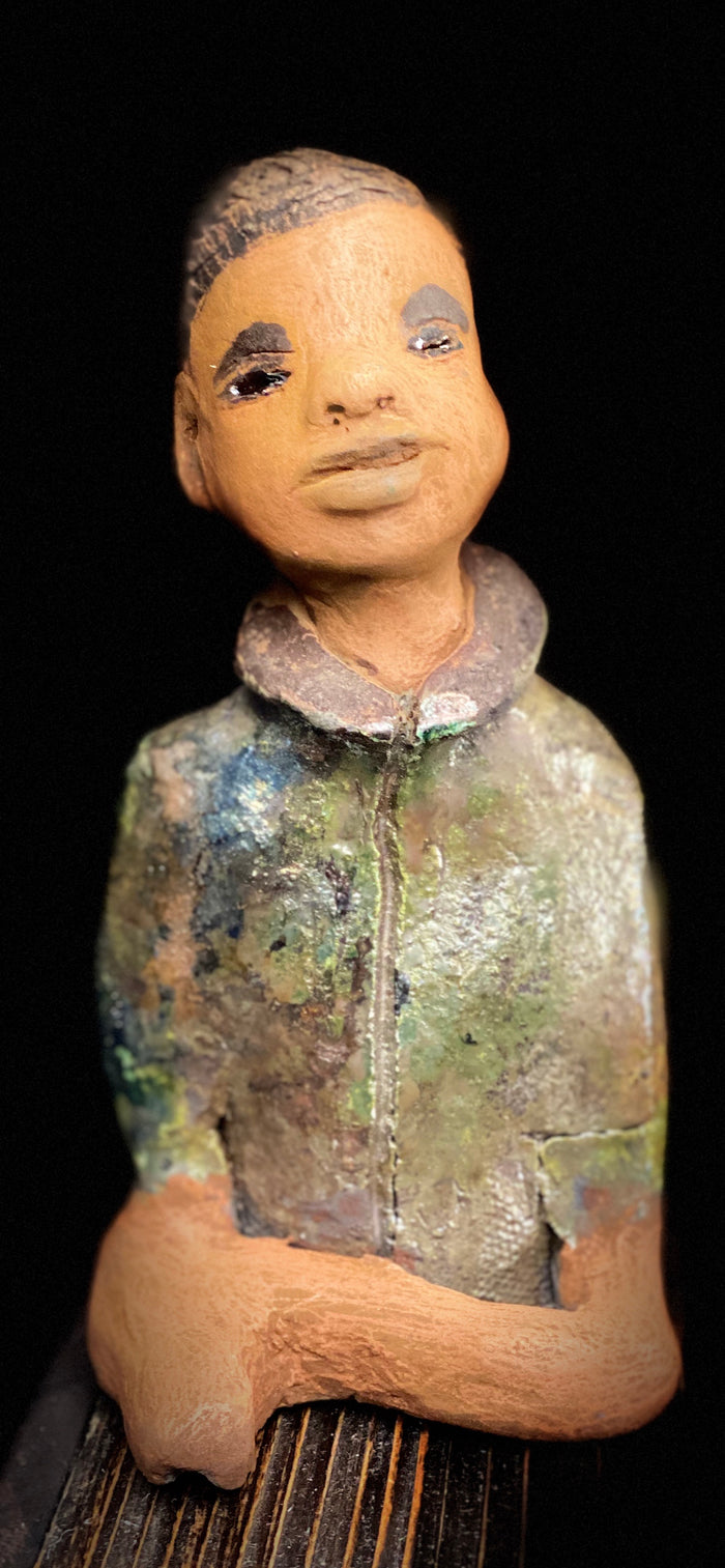 Ray is one confident teen who is ready to make his mark!  Ray stands 7"x 3" x 3" and weighs 14 ozs. He has a green metallic jacket with a high collar . Ray complexion is honey brown. His arms are folded as he ponders which college scholarship to accept!!