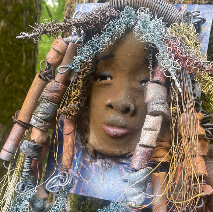 Valarie is mounted  5” x 8 x 1 and weighs 1.13 lbs.   She has a contagious smile. Valarie face has a lovely honey brown complexion. She has over 20 handmade raku fired beads  Over 60 feet of 16 and 24 gauge twisted wire for hair!