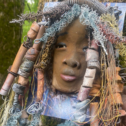 Valarie is mounted  5” x 8 x 1 and weighs 1.13 lbs.   She has a contagious smile. Valarie face has a lovely honey brown complexion. She has over 20 handmade raku fired beads  Over 60 feet of 16 and 24 gauge twisted wire for hair!