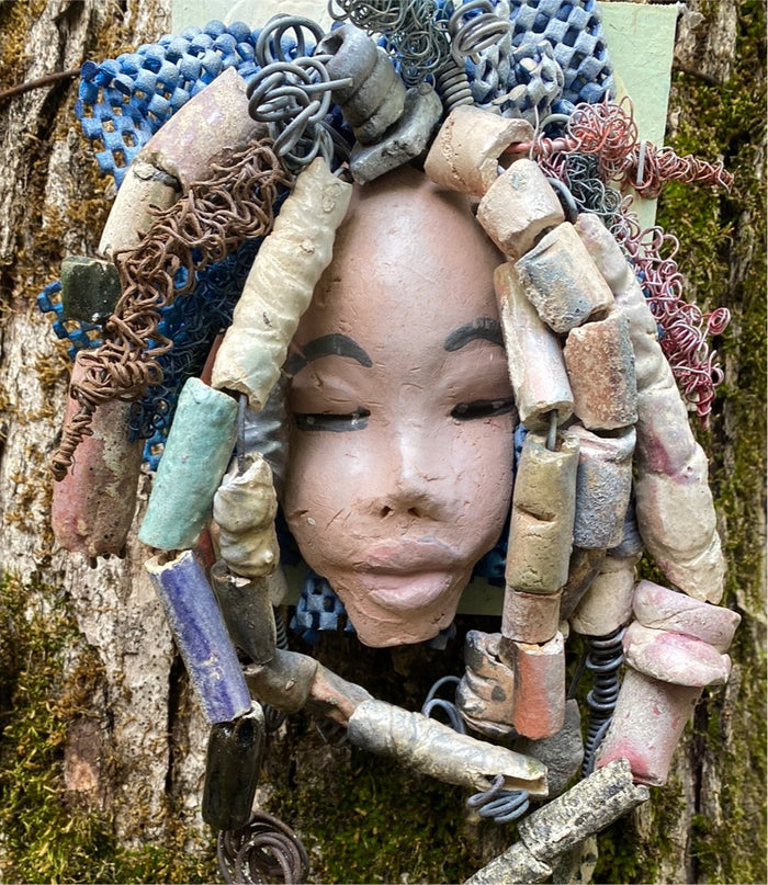 Zaire is mounted on a  5"x 6" painted wood canvas. I spent about 4 hours or more just  fixing her hair and attaching beads!  Zaire has over 100 feet of 16 and 24 gauge wire for hair. Zaire has a white crackle face with dark gray lips. She weighs 2.10 lbs  and is ready to be hung!