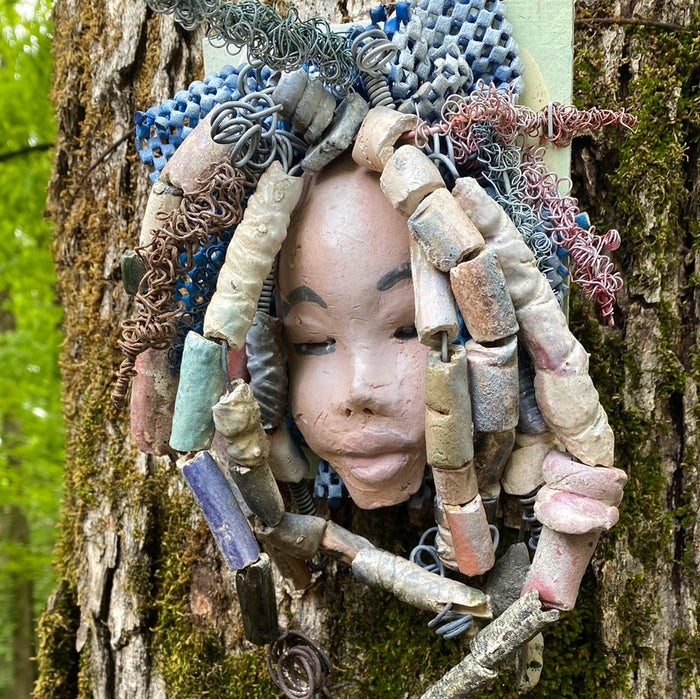 Zaire is mounted on a  5"x 6" painted wood canvas. I spent about 4 hours or more just  fixing her hair and attaching beads!  Zaire has over 100 feet of 16 and 24 gauge wire for hair. Zaire has a white crackle face with dark gray lips. She weighs 2.10 lbs  and is ready to be hung!