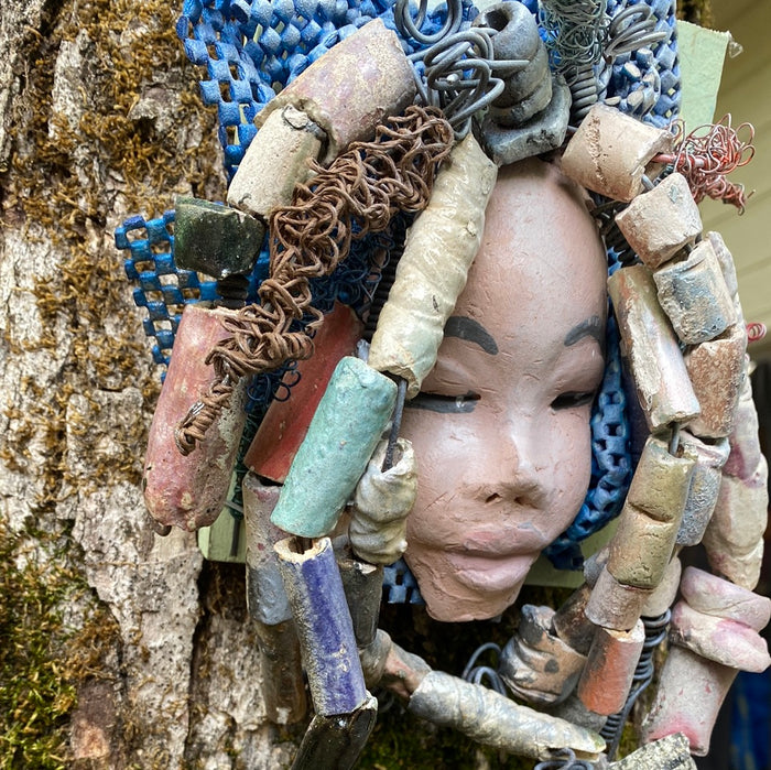 Zaire is mounted on a  5"x 6" painted wood canvas. I spent about 4 hours or more just  fixing her hair and attaching beads!  Zaire has over 100 feet of 16 and 24 gauge wire for hair. Zaire has a white crackle face with dark gray lips. She weighs 2.10 lbs  and is ready to be hung!