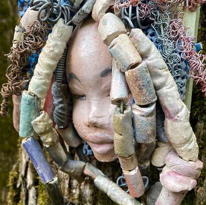 Zaire is mounted on a  5"x 6" painted wood canvas. I spent about 4 hours or more just  fixing her hair and attaching beads!  Zaire has over 100 feet of 16 and 24 gauge wire for hair. Zaire has a white crackle face with dark gray lips. She weighs 2.10 lbs  and is ready to be hung!